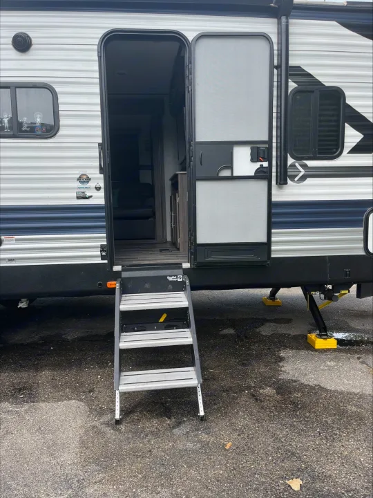 Modern RV rental: open door, Solid Steps, and inviting interior reveal campsite comfort.. Crossroads RV Zinger Lite 2021