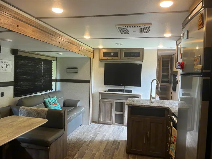 Spacious RV rental interior featuring a living area, kitchen, and TV. Ideal for travel adventures!. Crossroads RV Zinger Lite 2021