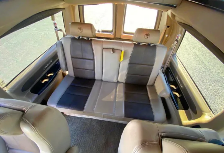 Spacious RV rental interior with comfy two-tone seating, cup holders, and natural light from large windows.. Chevrolet 2500 2019