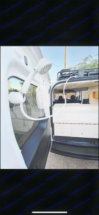 Portable outdoor shower setup on a white camper van, revealing the interior bed and storage. Ideal for your next RV rental adventure.. Dodge Dodge promaster city 2016