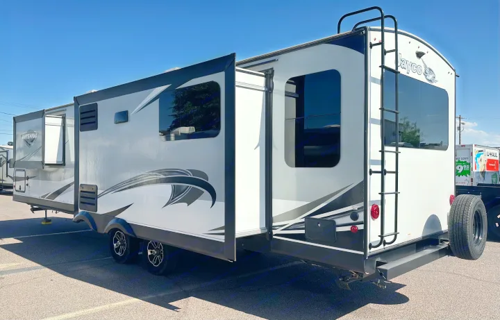White and black Jayco White Hawk travel trailer RV rental with multiple slide-outs extended, ready for use.. Jayco White Hawk 2020