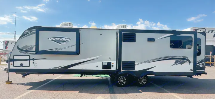 This sleek, modern White Hawk travel trailer RV is ready for your next rental adventure, featuring an extended slide-out section.. Jayco White Hawk 2020