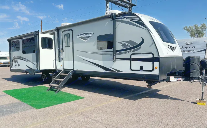 A modern light grey and white Jayco White Hawk travel trailer with slide-out extended, great for an rv rental.. Jayco White Hawk 2020