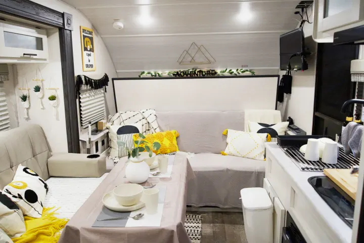 Step inside this stylish RV rental, boasting a cozy dining area, comfy lounge, and "ADVENTURE" decor for glamping comfort.. Forest River R-Pod 193 2022