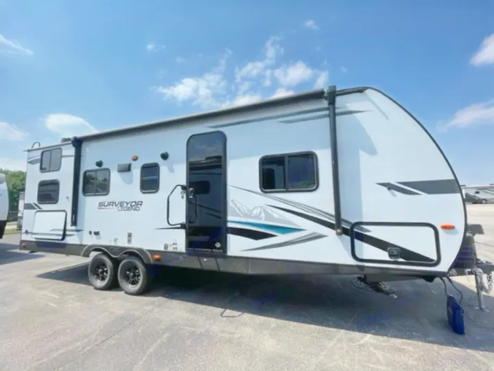 Ready for adventure: A white Surveyor Legend travel trailer with black accents & extended awning, ideal for rv rental.. Forest River Surveyor Legend 2024