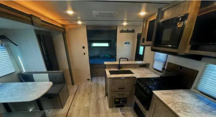 This RV rental offers a well-equipped kitchen, comfortable dining area, and cozy bedroom. Ideal for your next adventure.. Forest River Surveyor Legend 2024