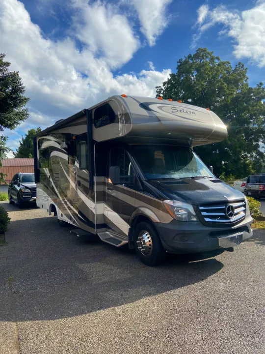 A modern Forest River Solera Class C RV rental, on a Mercedes Sprinter chassis, parked on a sunny day.. Solera Solera Motorhome 2014