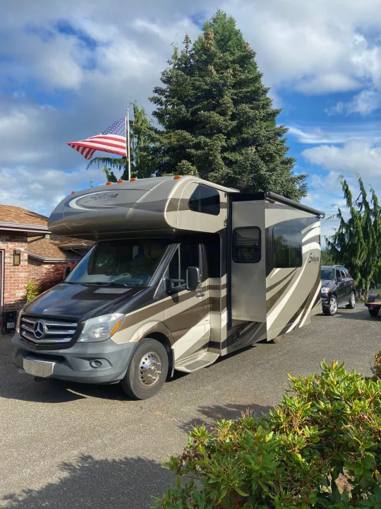 Parked on a sunny day, this modern Solera Mercedes-Benz Sprinter RV rental offers spacious comfort for your next road trip.. Solera Solera Motorhome 2014