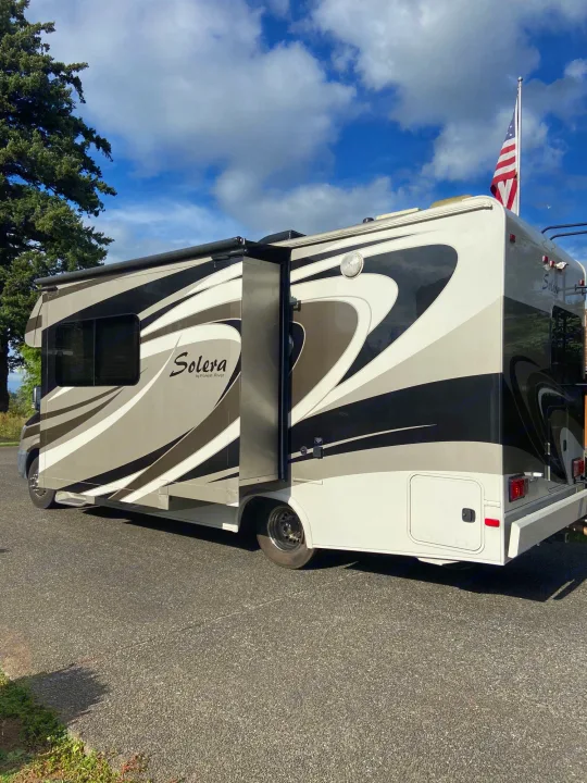 This RV rental, a "Solera by Forest River" class C motorhome, features a striking design, extended slide-out, and US flag.. Solera Solera Motorhome 2014