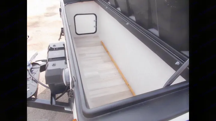 Discover this RV rental's spacious front storage compartment with light flooring and interior access.. Forest River A122S 2021