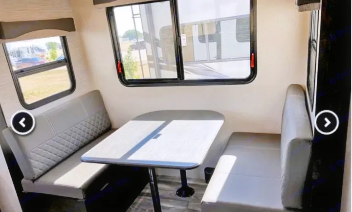 RV rental interior featuring a bright dinette area with comfy benches and large windows. Perfect for travel!. Highland Ridge RV Range Lite 2022