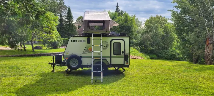 Explore outdoor adventure with this No Boundaries travel trailer RV rental, complete with a rooftop tent for elevated camping.. Forest River NoBo 10.6 2022
