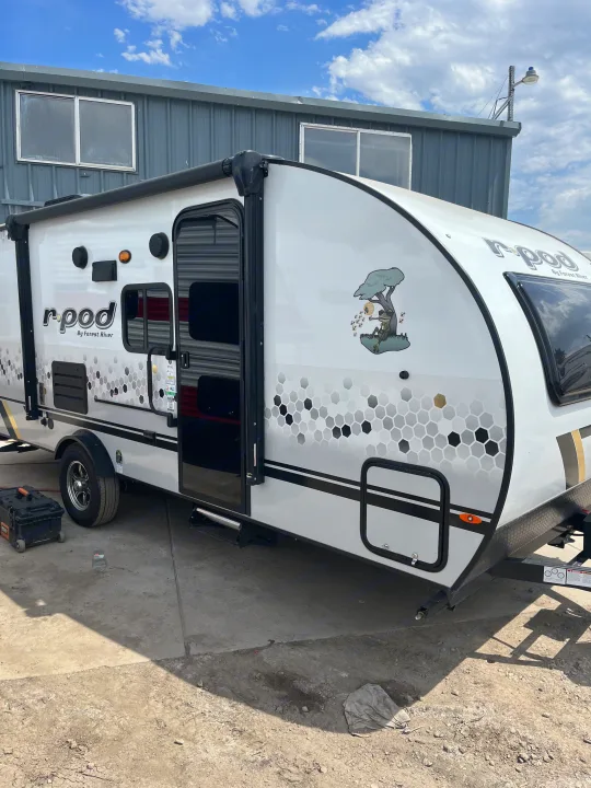 This R-pod travel trailer, perfect for your next RV rental camping trip, features a unique honeycomb design and cool frog decal.. Forest River R-Pod 193 2022