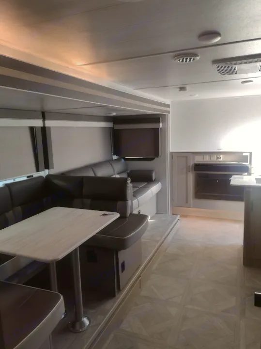 Modern RV rental interior: comfortable living space with U-shaped sofa, dining area, and full kitchen.. Forest River Salem Cruise Lite 2023