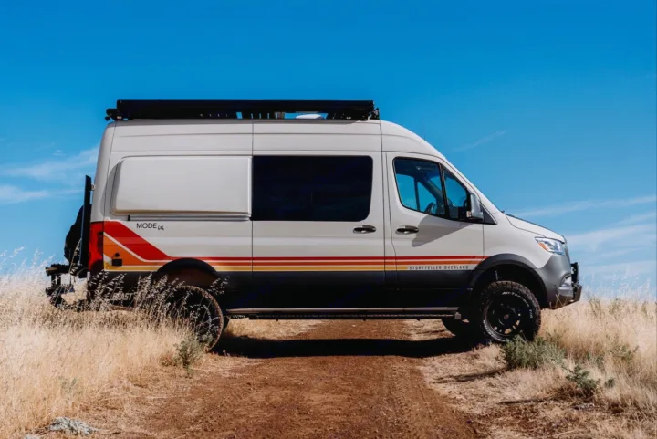 Storyteller Overland MODE 4x4 camper van, perfect for rv rental adventures, on a dirt path under a clear blue sky.. Storyteller Overland Storyteller Overland Class B 2023