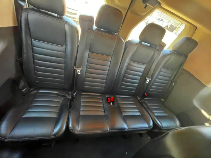 Comfortable black leather rear seats of an RV rental, providing ample interior space for your journey.. Ford Transit 350 XLT 2020