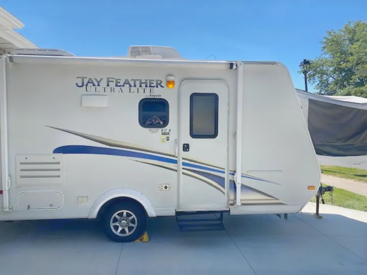 Jayco Jay Feather Ultra Lite RV travel trailer, ready for your next rv rental adventure. Side view with spare tire.. Jayco Jay Feather Ultra Lite 2012