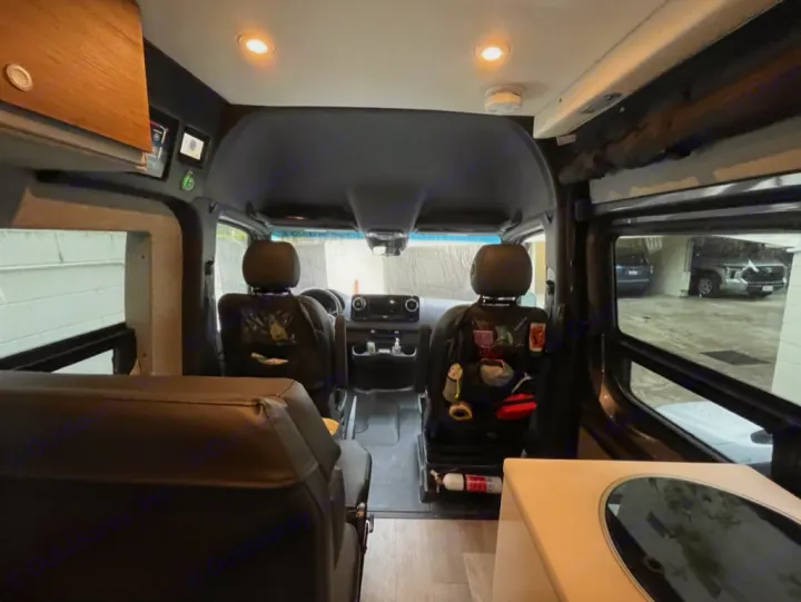 RV rental interior: looking forward past rear seating towards cockpit, with kitchenette counter on right.. Storyteller Overland Storyteller Overland Class B 2022