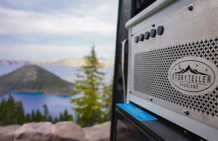 Storyteller Overland RV rental panel with a stunning view of Crater Lake and Wizard Island. Perfect for adventure travel.. Storyteller Overland Storyteller Overland Class B 2022