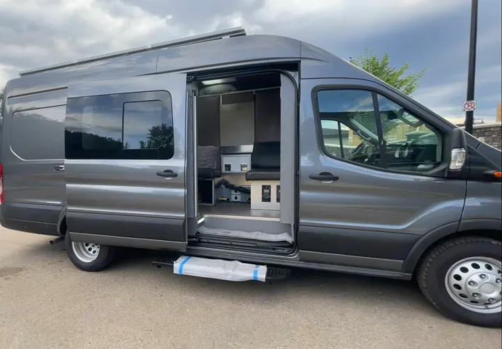 Modern gray camper van, side door open to reveal custom interior. Great for your next RV rental.. Other Transit 2022