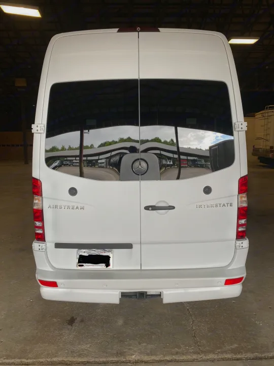 White Mercedes-Benz Airstream Interstate RV van, ideal for rv rental. Rear view with hitch receiver.. Airstream Interstate 2016