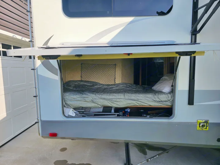 This RV rental features an open expandable bed compartment with under-bed storage, ideal for camping adventures.. Open Range RV Light 2014