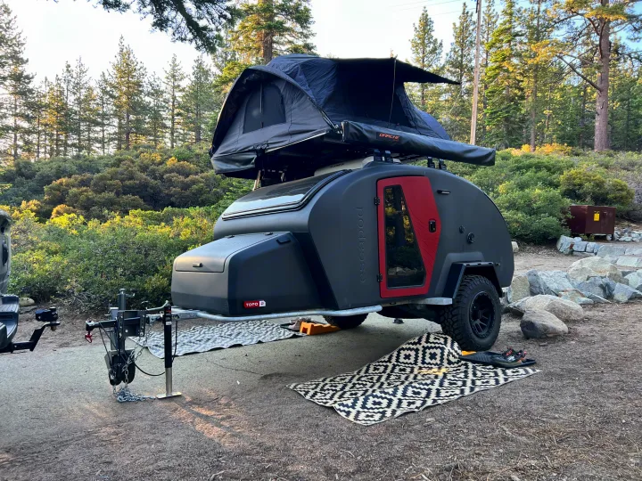 Modern off-road escapod camper trailer with rooftop tent, a great RV rental for wooded adventures.. Escapod Escapod Trailer 2023