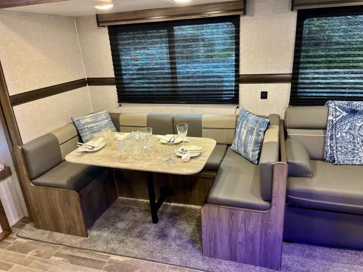Experience comfort in this RV rental! Spacious U-shaped dinette with set table, plush seating, and privacy blinds.. Crossroads RV Zinger Lite 2022