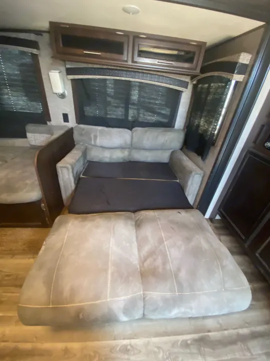 RV rental interior with a comfortable pull-out sofa bed, cabinets, and windows. Ideal for your next camper trip.. Jayco Jay Flight 2018