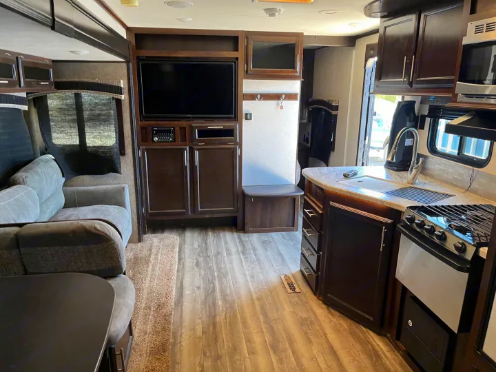 Spacious RV rental interior showcasing living room, kitchen, and entertainment unit.. Jayco Jay Flight 2018