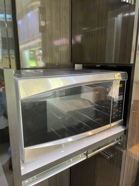 A Frigidaire microwave on a pull-out shelf, common in RV rental kitchens, demonstrating clever space-saving design.. Airstream International 2014