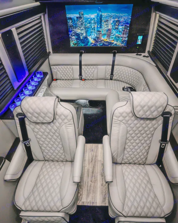 This luxury RV rental interior features plush gray seating, a large TV, and cool blue accent lights. Enjoy the ride!. Midwest Automotive Designs Ultimate Coach 2023