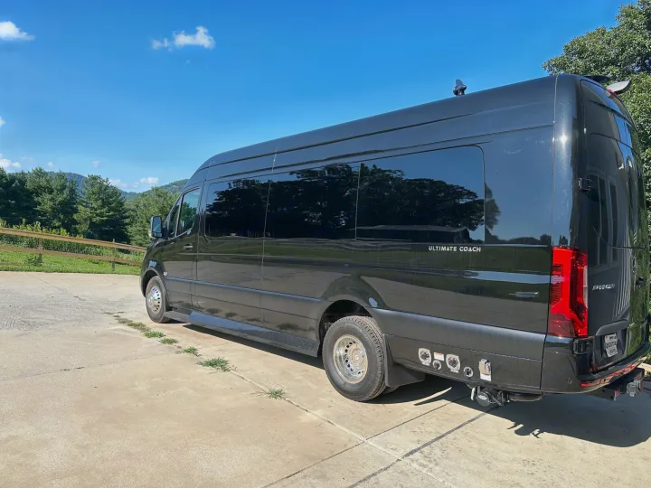 Luxurious black Mercedes-Benz Sprinter RV rental, an Ultimate Coach, parked outdoors on a sunny day.. Ultimate Toys Ultimate Coach 2024