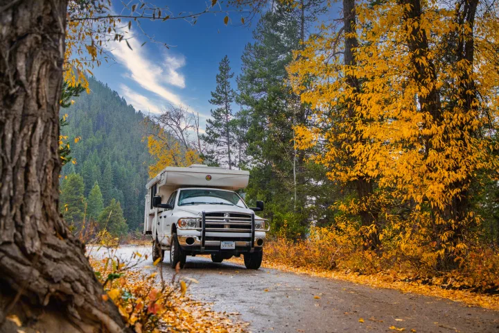 Adventure awaits! This RV rental, a white truck camper, is perfect for autumn trips. Enjoy vibrant fall foliage and scenic mountains.. Hallmark Everest 2011