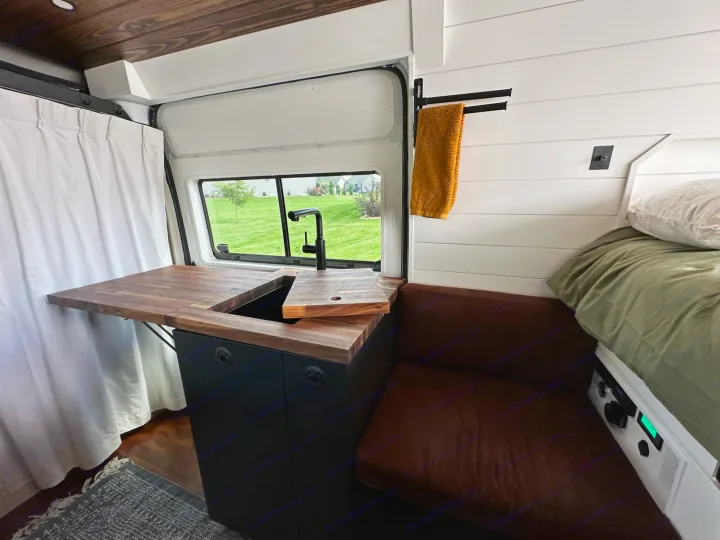 This RV rental van interior features a modern kitchen, comfortable bed, and versatile living space.. RAM ProMaster 2500 2022
