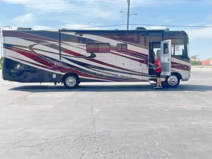 Spacious RV motorhome with unique design. Man by door, possibly for an RV rental pickup. Ready for adventure!. Georgetown XL 2013