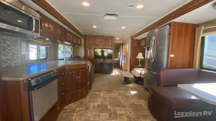 Enjoy this spacious RV rental interior: kitchen, living area with TV, dining booth, and comfortable seating for your travels.. Georgetown XL 2013