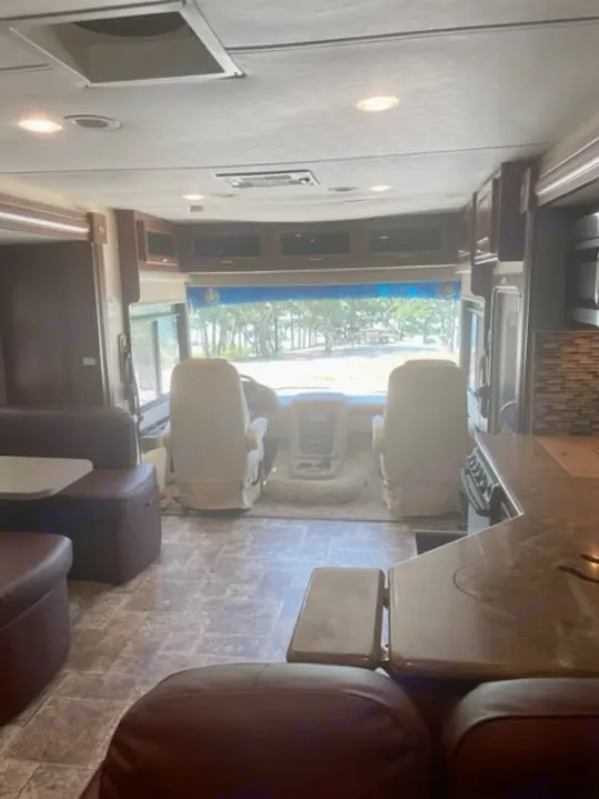 Spacious RV rental interior looking forward from the rear, showing the cockpit, living area, and kitchen.. Georgetown XL 2013