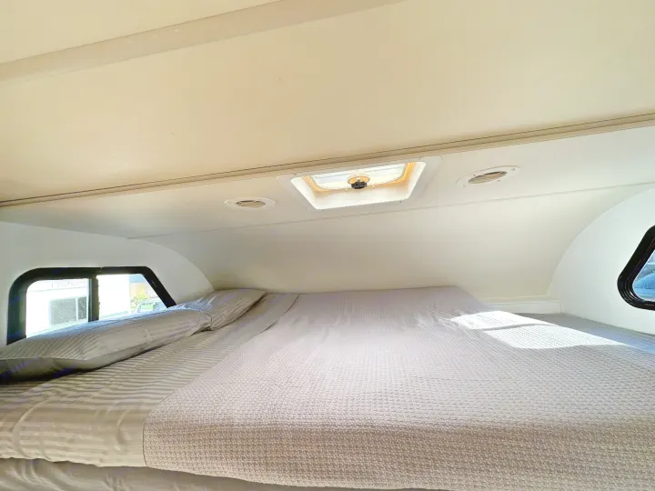 RV rental overhead bed. Spacious and cozy sleeping area with skylight and window view.. Thor Majestic 2012
