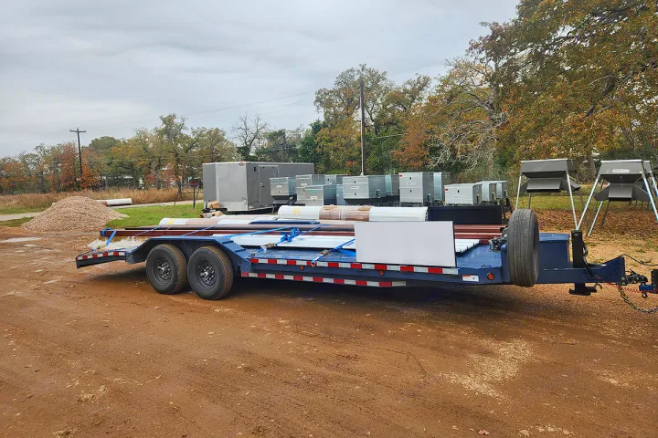 Trailer with site prep materials, utility boxes & feeders for outdoor projects. Supports your next RV rental adventure.. Custom 24ft Buggy Hauler 2023