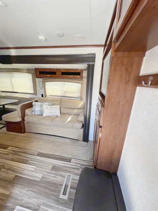 An inviting RV rental living space featuring a comfortable sofa, dining area, and wood-look flooring.. Jayco Jay Flight 2017