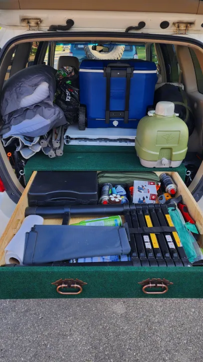 Organized car camping setup in trunk, perfect for an RV rental adventure! Features cooler, gear, and custom storage drawer.. Toyota Highlander 2005