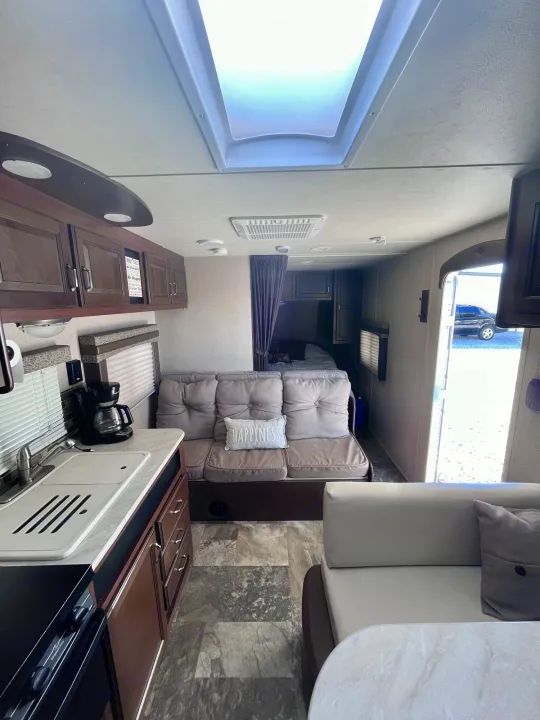 Step inside this RV rental: modern kitchen, cozy living space with sofa and skylight, plus a private bedroom. Ready for your adventure!. Jayco Jay Flight 2015