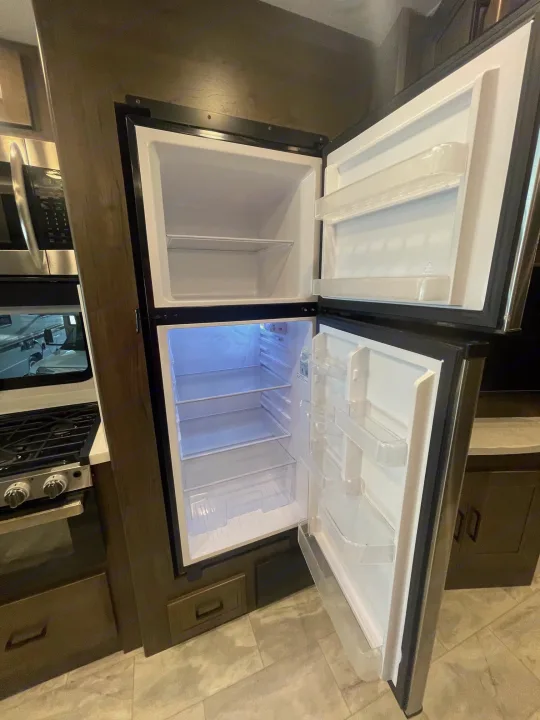 Bright, empty refrigerator in an RV rental kitchen, perfect for your next road trip.. Coachmen MIRADA 35ESF 2026