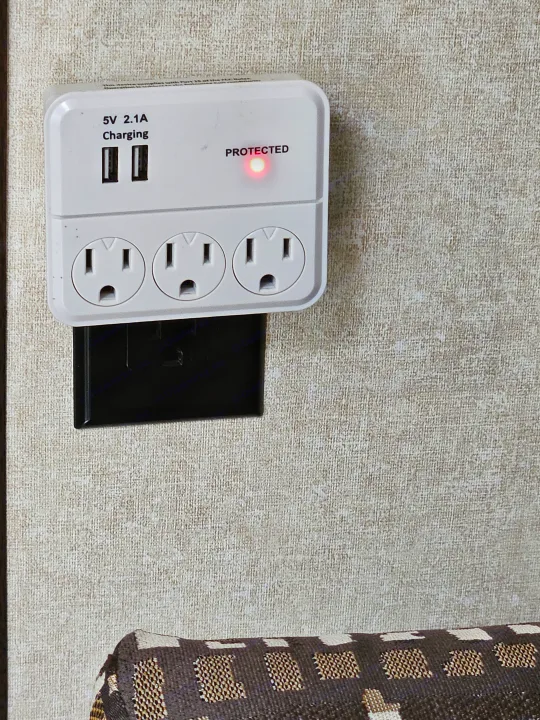 RV rental tech: White power strip with 3 AC outlets, 2 USB charging ports (5V 2.1A), & 'PROTECTED' surge light on textured wall.. Jayco Jay Flight SLX 2019