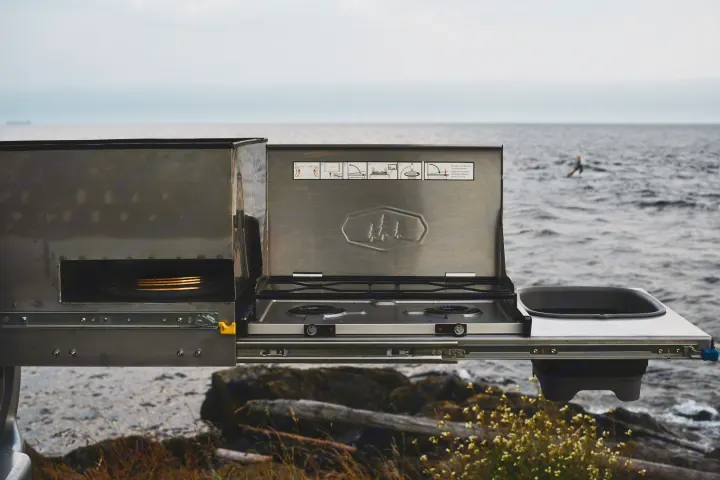 This RV rental features a pull-out outdoor kitchen: a 2-burner stove, sink, & dish storage, perfect for scenic camping meals.. Mitsubishi Delica 2005