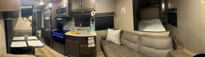 RV rental showcasing a well-equipped kitchen, dining area, comfortable sofa, and compact bedroom, ready for adventures.. Jayco Jay Flight SLX 2021