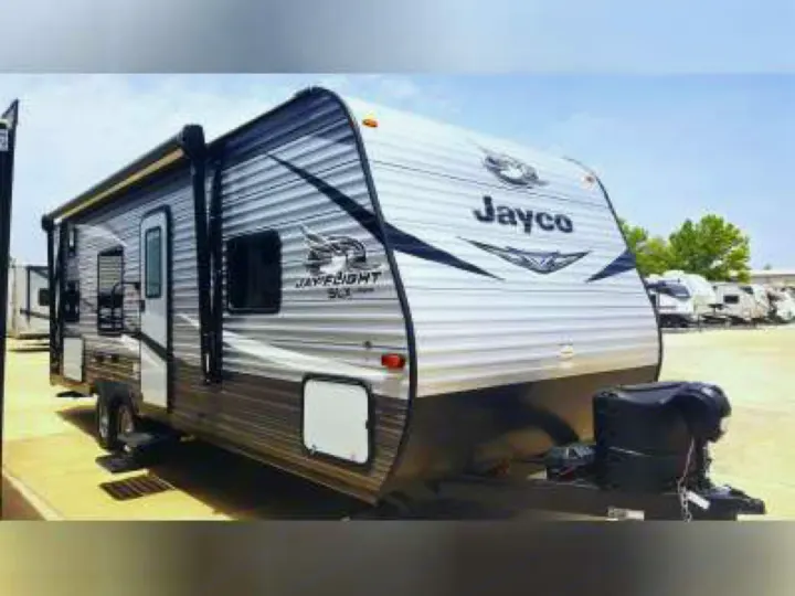 A silver Jayco Jay Flight SLX travel trailer, a popular recreational vehicle model ideal for an RV rental.. Jayco Jay Flight SLX 2021