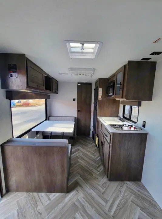 Explore this modern RV rental: compact kitchen, cozy dinette, and sleek flooring. Your next road trip awaits!. Forest River Salem 2022