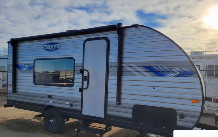 Bright, sunny view of a new Salem FSX travel trailer. Ready for your next RV rental and camping adventure!. Forest River Salem 2022